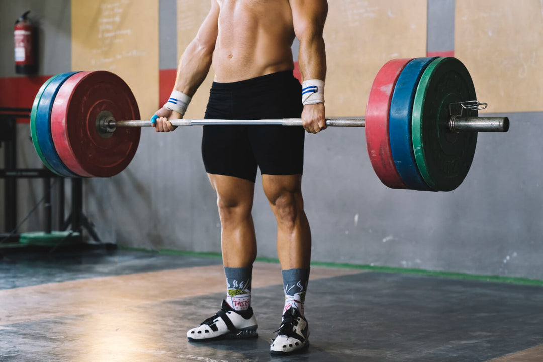 A man holding a olympic barbell