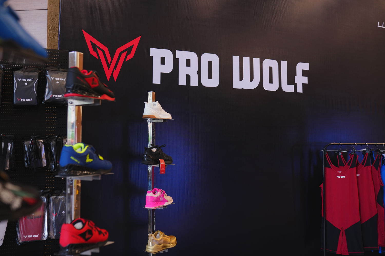 Display of shoes and clothing with 'Pro Wolf' branding on a dark background